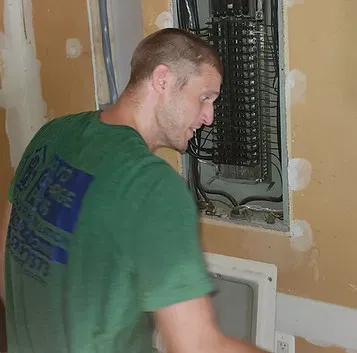Technician servicing a residential electrical panel