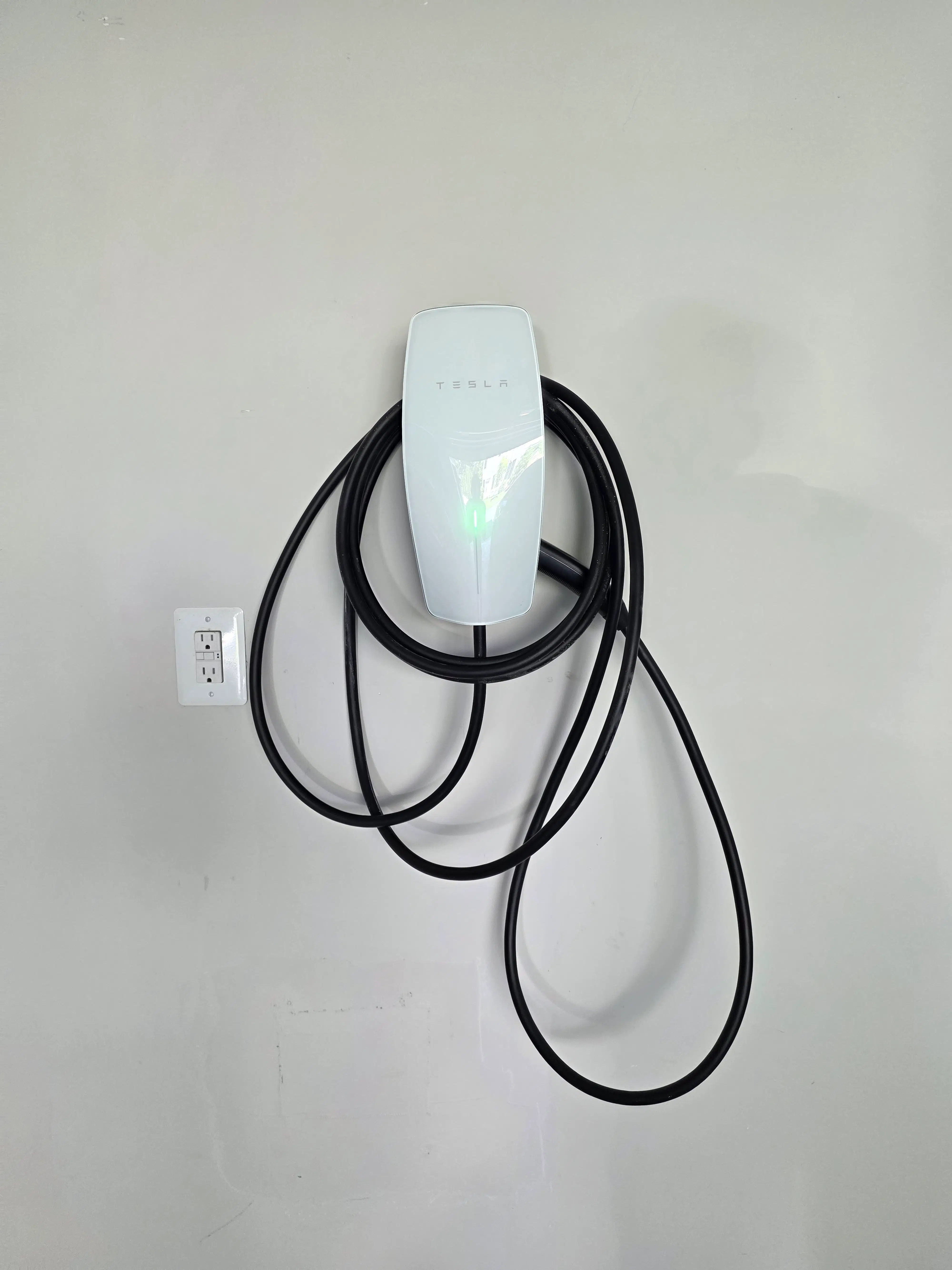 Dual EV charger installation with concealed wiring, clean finished work, and minimal visible drywall disruption in a Northern Virginia garage