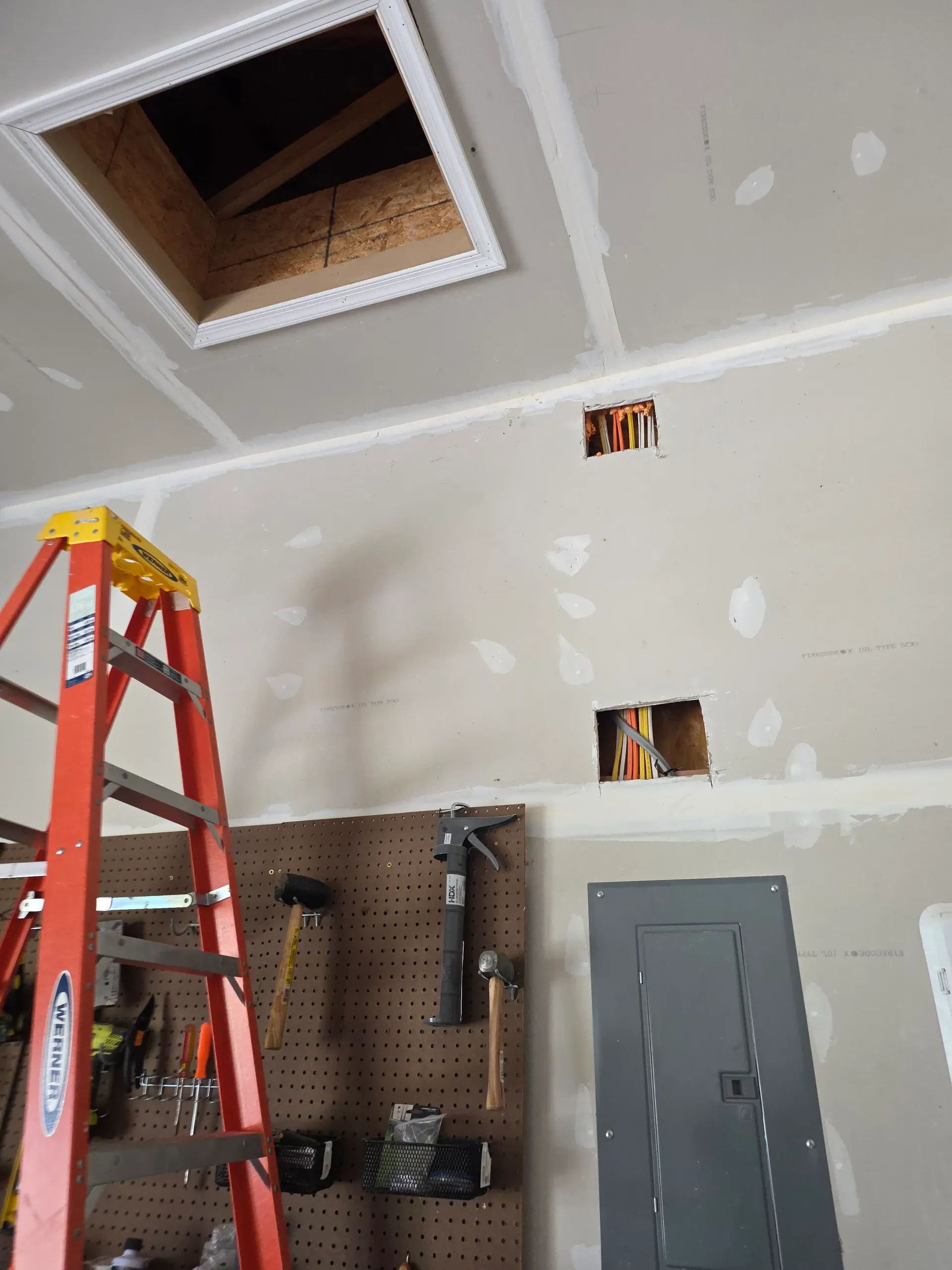 Electrical cables and junction points being routed before a residential wall is finished